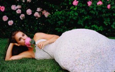 Natalie Portman in a White Dress on the Grass with a Rose