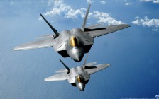 F-22 Raptors Over the Pacific Ocean