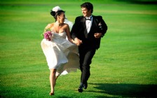 Wedding Couple running in a Green Field